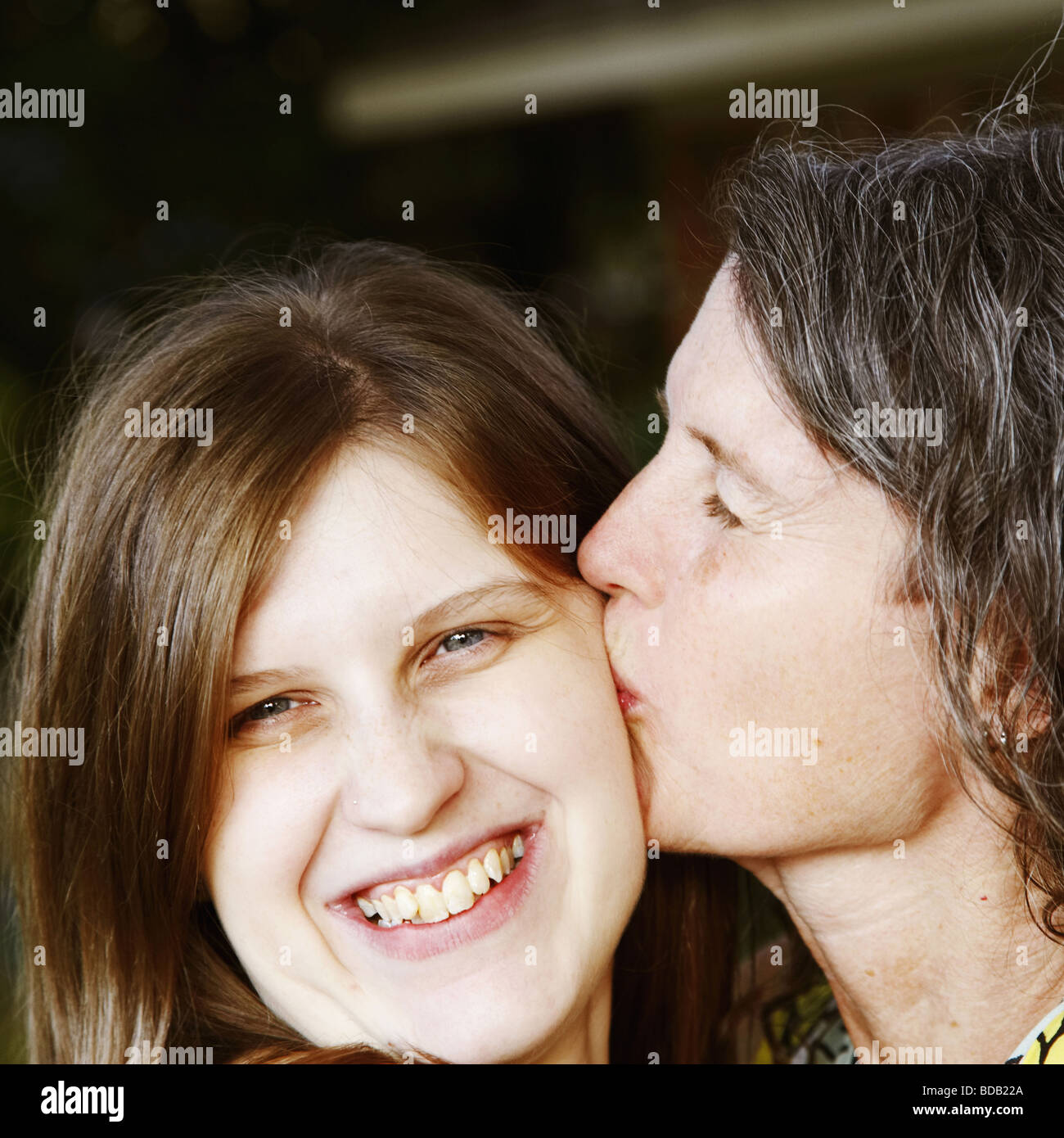 Close-up of a mature woman kissing her daughter Stock Photo