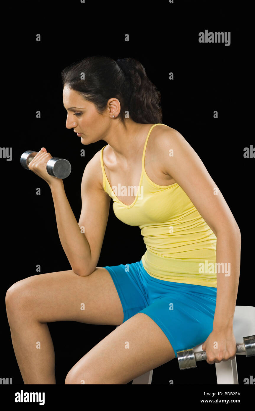 Woman exercising with dumbbells Stock Photo