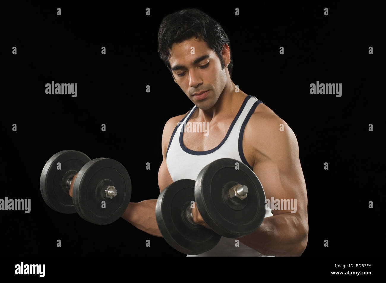 Man exercising with dumbbells Stock Photo