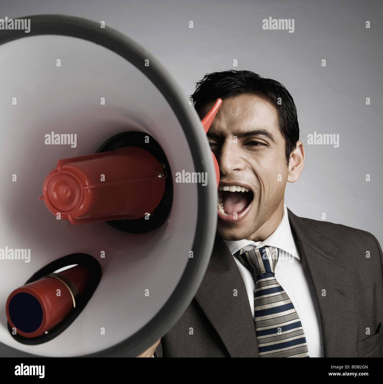 Businessman shouting into a megaphone Stock Photo Alamy