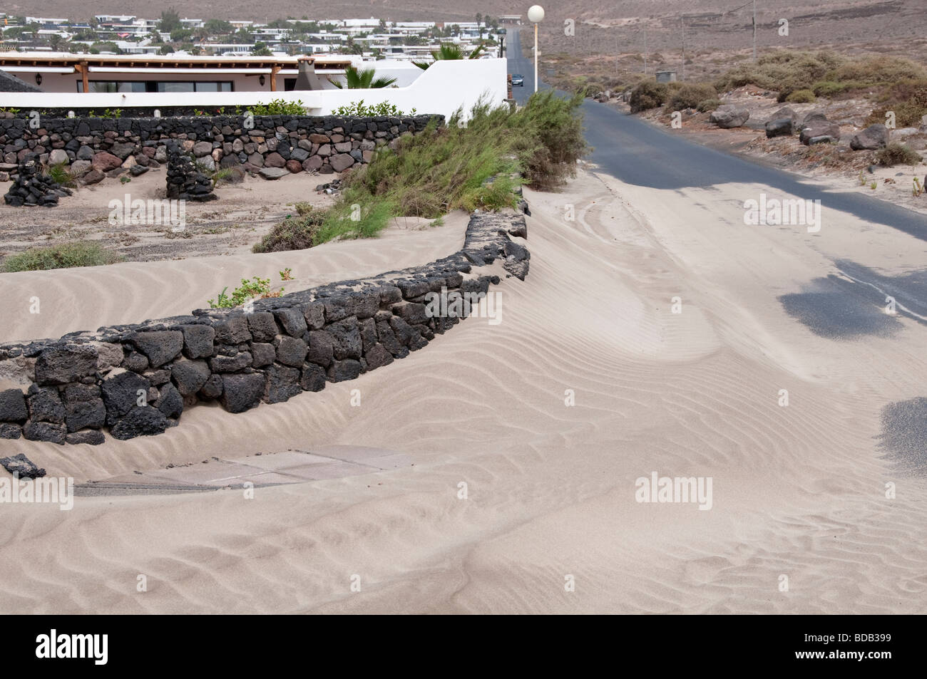 Wind blown sand covering wall.  Famara Lanzarote Canary Islands Stock Photo