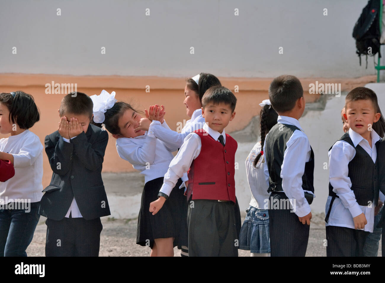 Mongolian schoolchildren play while queued in a line, Ulaan Baatar, Mongolia Stock Photo