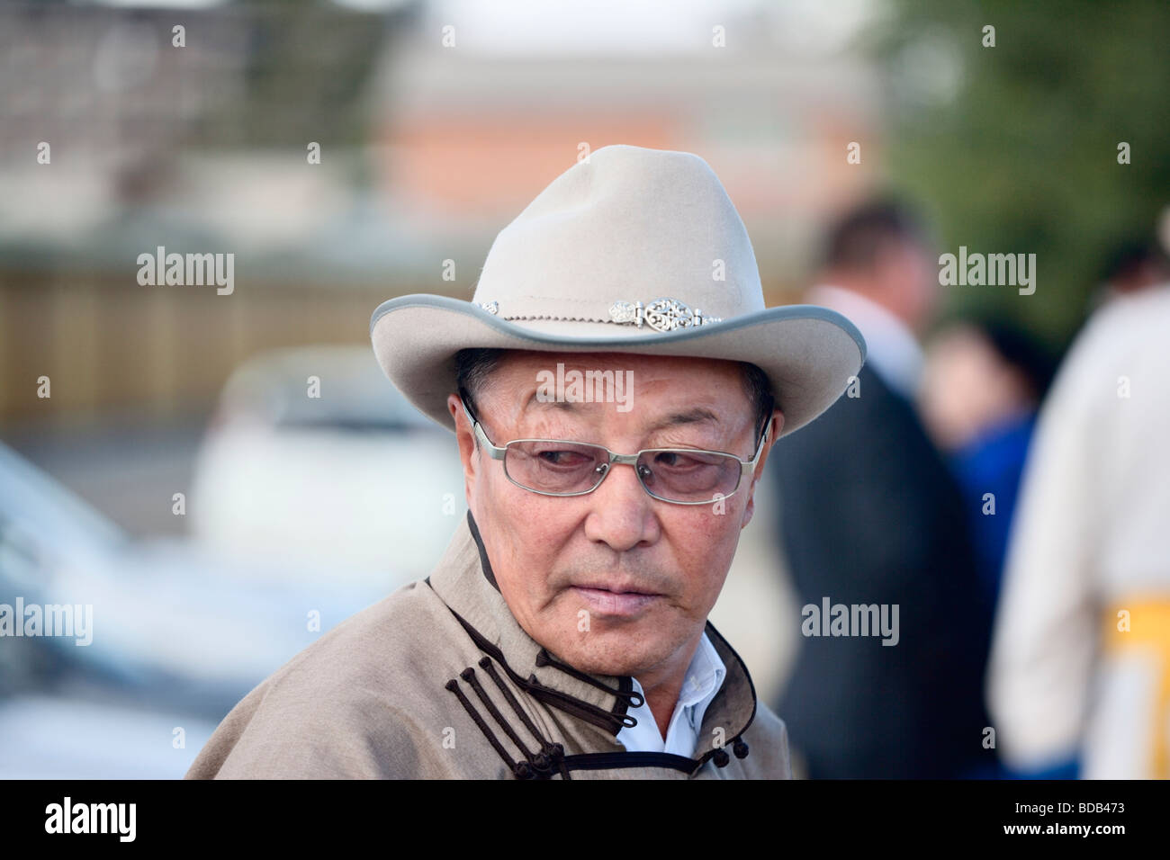 Dressedup Mongolian man wearing a cowboy hat glances sideways, Ulaan