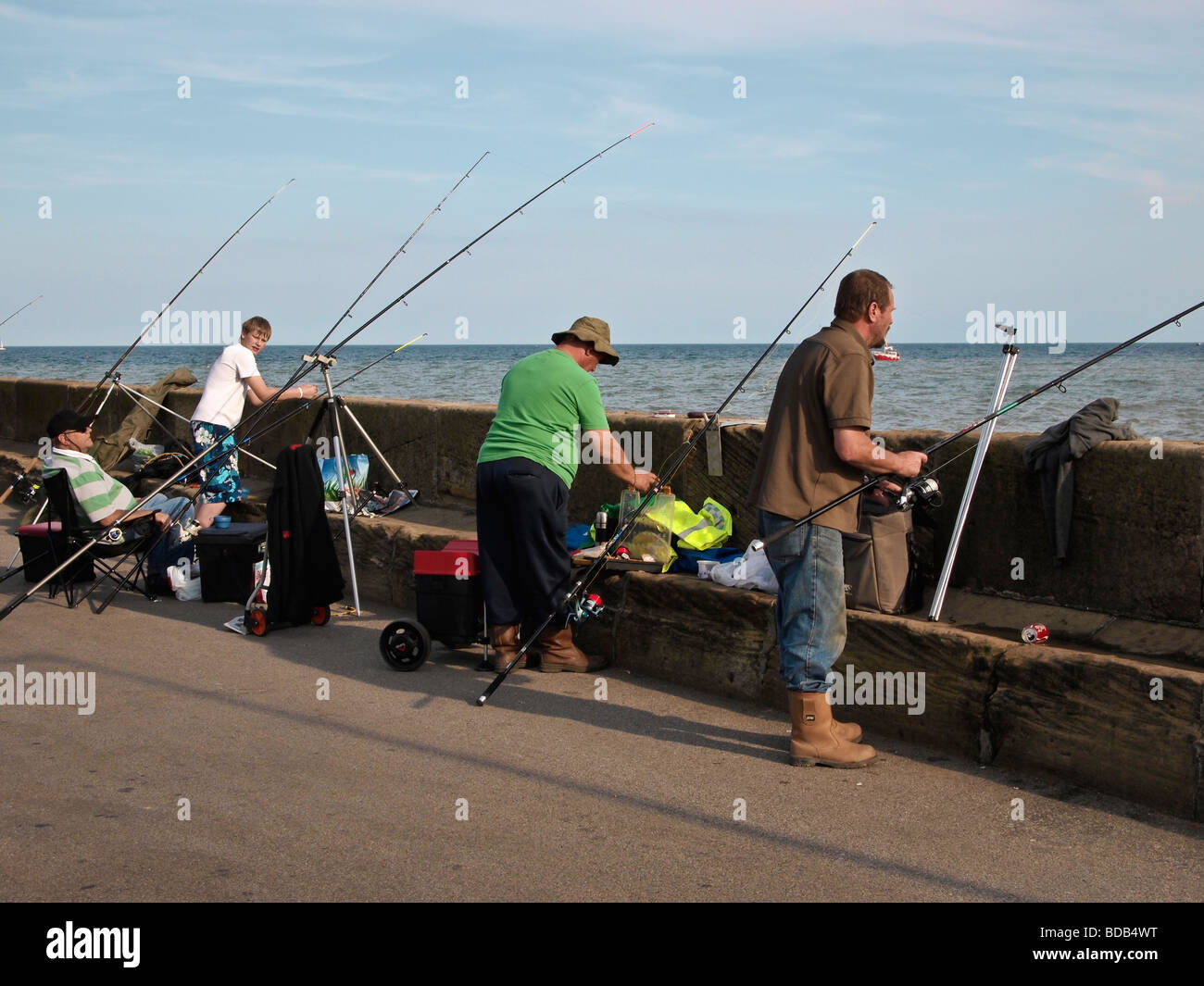 Fishing from Harbour wall at Bridlington East Yorkshire UK Stock Photo