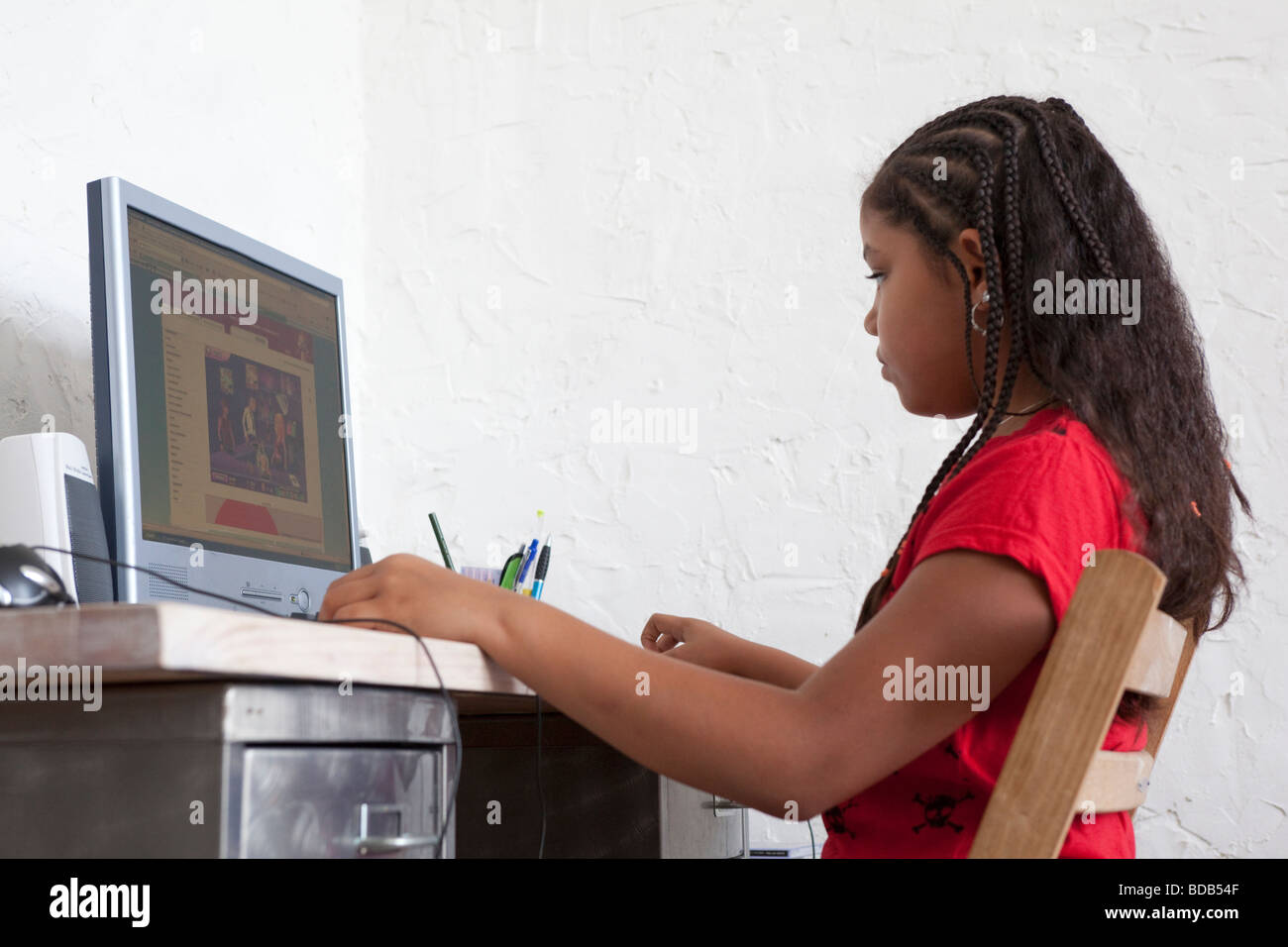 Little girl is behind a computer Stock Photo - Alamy