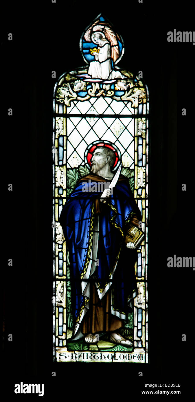 Stained Glass Window by William Morris & Co. depicting Saint Bartholomew the Apostle with a flaying knife, Earls Barton Church Northamptonshire Stock Photo
