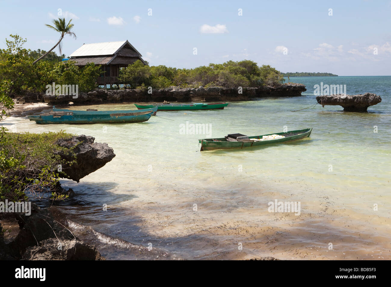 Indonesia Sulawesi Hoga Island small dugout boats moored in small bay Stock Photo
