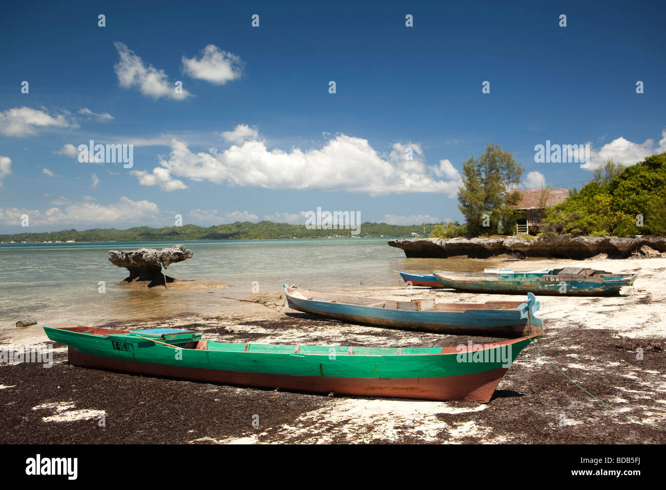 Indonesia Sulawesi Hoga Island small dugout boats moored in small bay Stock Photo