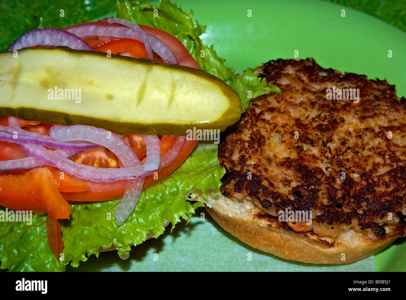 Deluxe pan fried crab cake burger dill pickle slice Stock Photo Alamy