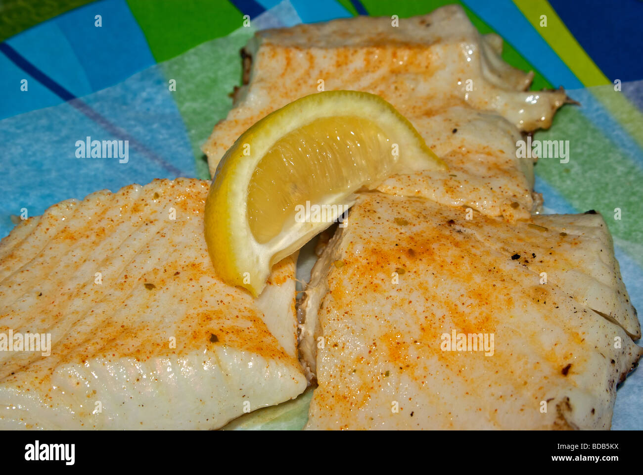 Baked halibut fillet lemon wedge Stock Photo Alamy