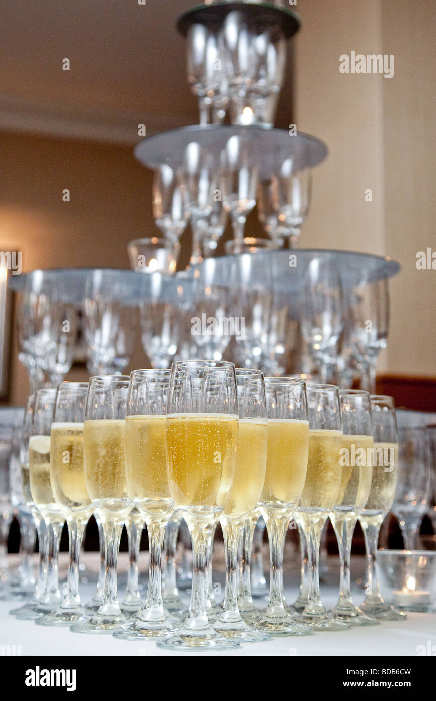 A champagne fountain with champagne in the lower glasses Stock Photo