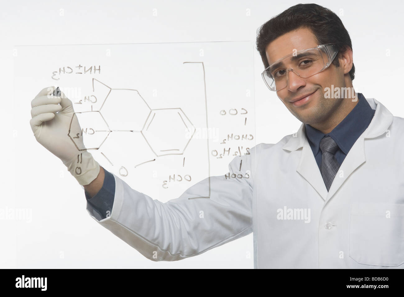 Scientist writing chemical formula Stock Photo