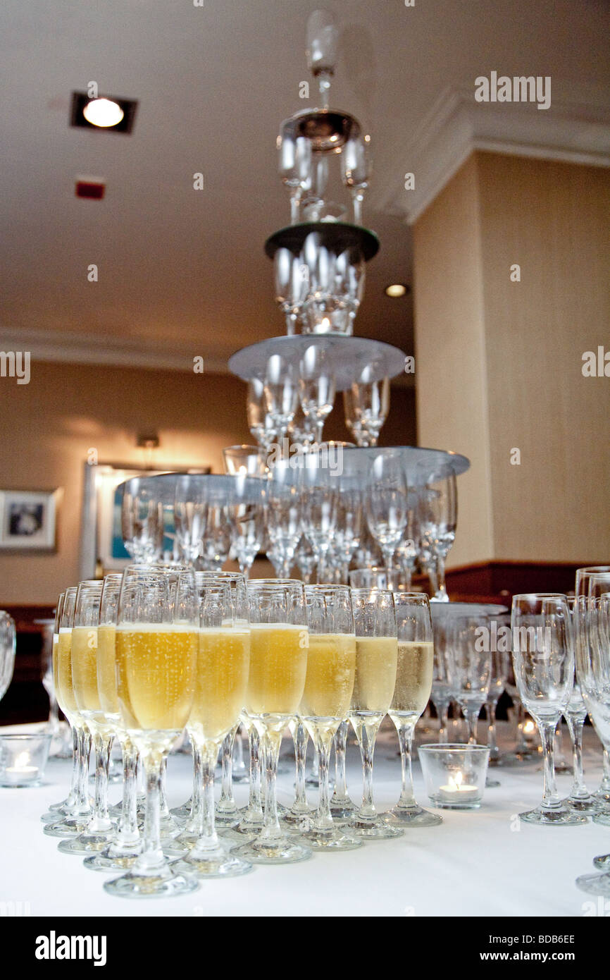 A champagne fountain with champagne in the lower glasses Stock Photo