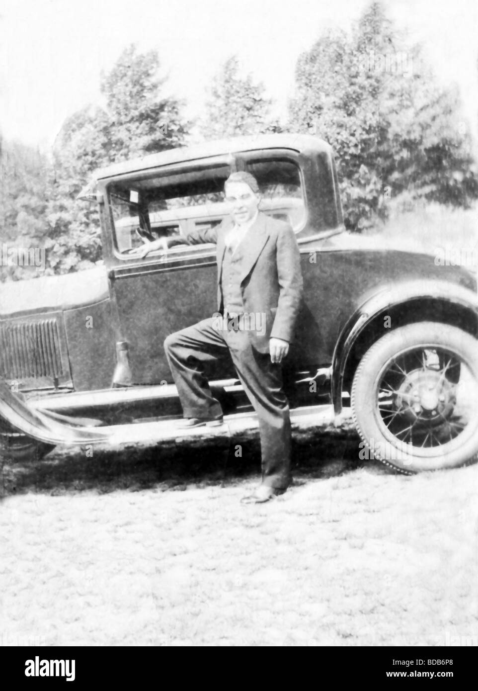 A  man stands with his two door Model T Ford in the city of New Bedford, Massachusetts, around 1930. Stock Photo