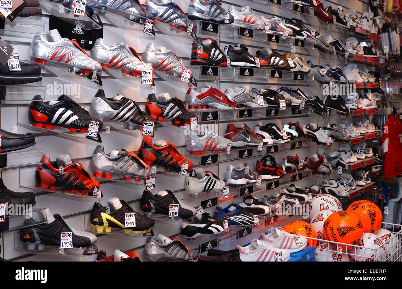 A display of football and soccer boots in a retail shop Stock Photo - Alamy