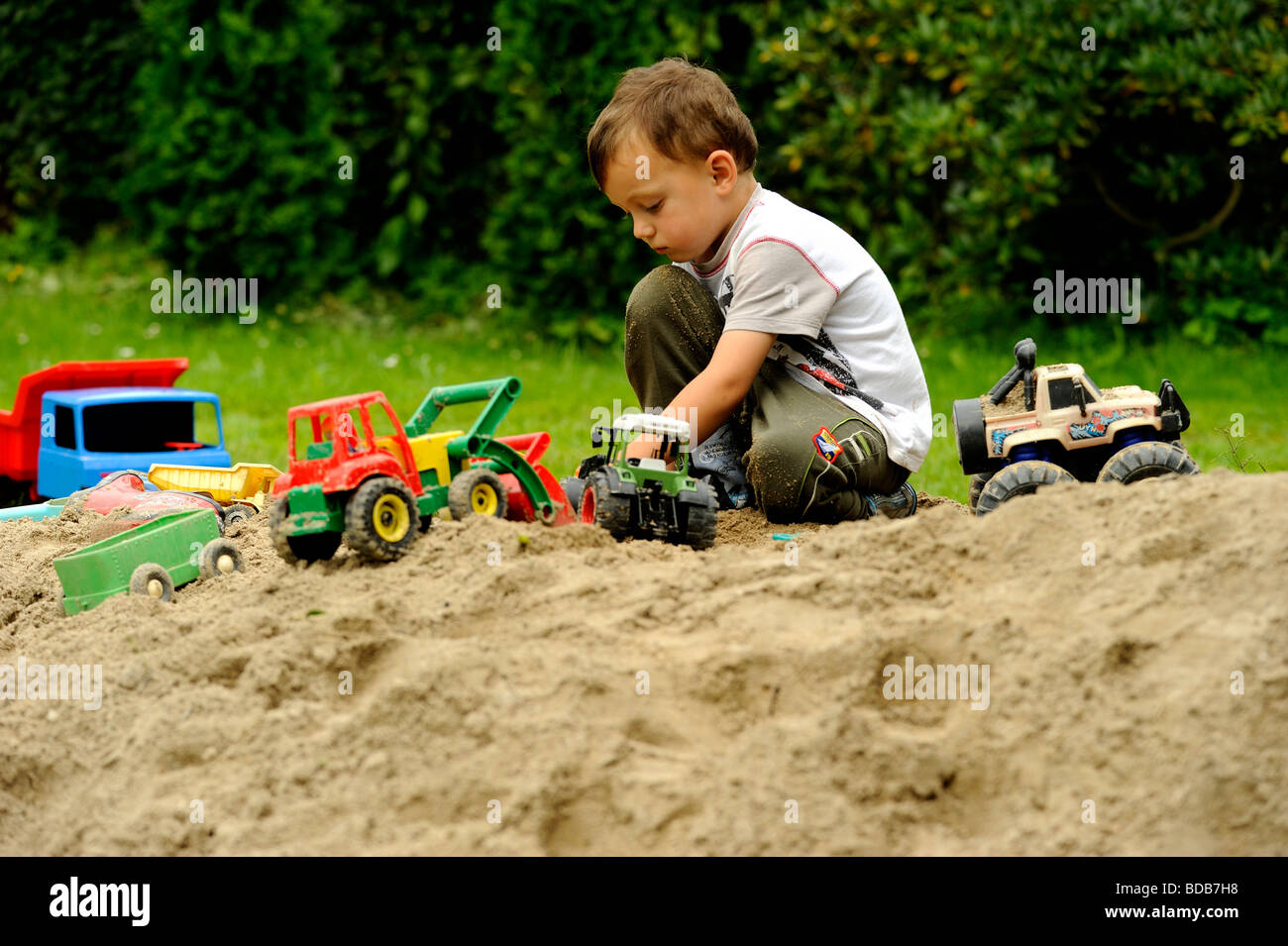 Child Boy playing outdoors Stock Photo - Alamy