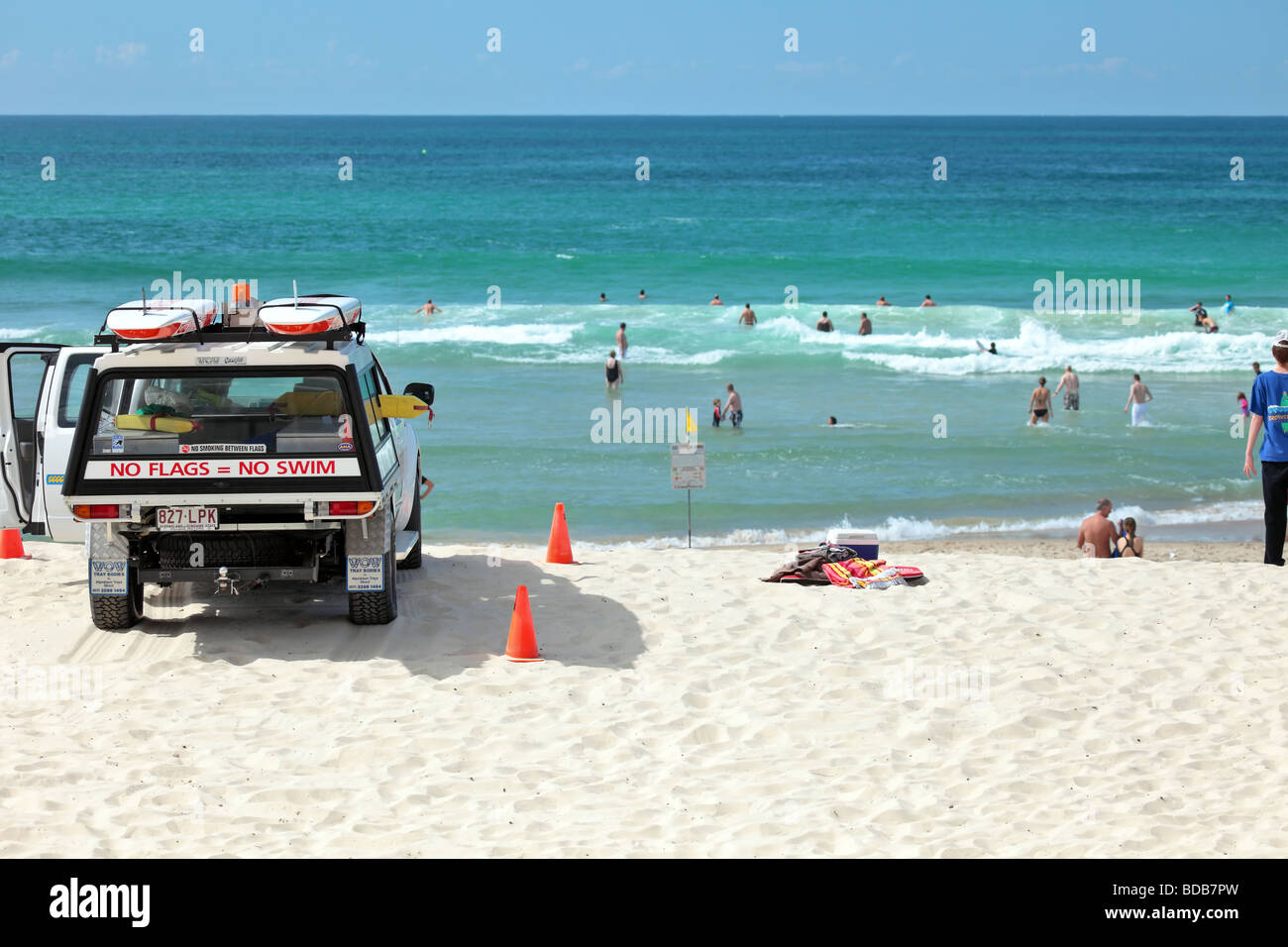 Australian lifeguard monitors swimmers from his vehicle Stock Photo