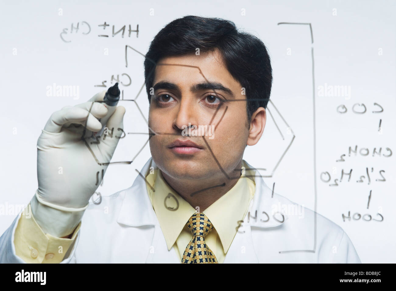 Scientist writing chemical formula Stock Photo