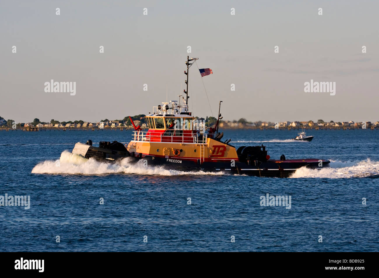 Tugboat 'Freedom' moving rapidly through the water in Boston Harbor. Stock Photo