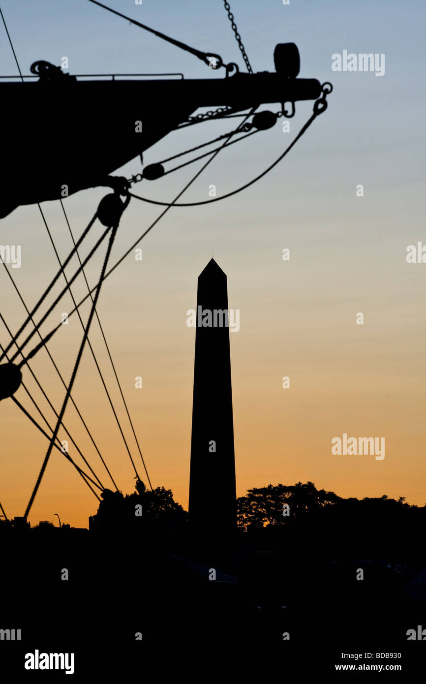 Bunker Hill Memorial in Charlestown, Massachusetts at sunset with tall ship yardarm in foreground. Stock Photo