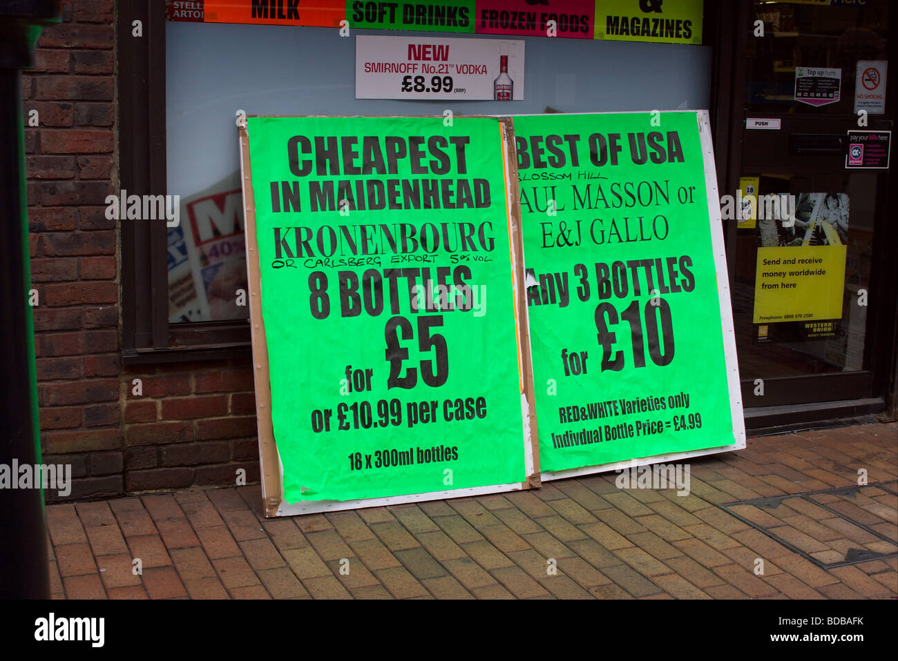 Hoarding signs for cheap alcoholic drinks outside a shop in Maidenhead Berkshire England UK Stock Photo