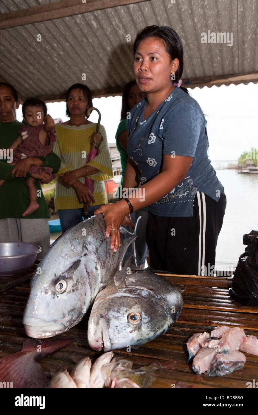 Indonesia Sulawesi Kaledupa Island Ambuea village local fish market woman selling large trevally fish Stock Photo