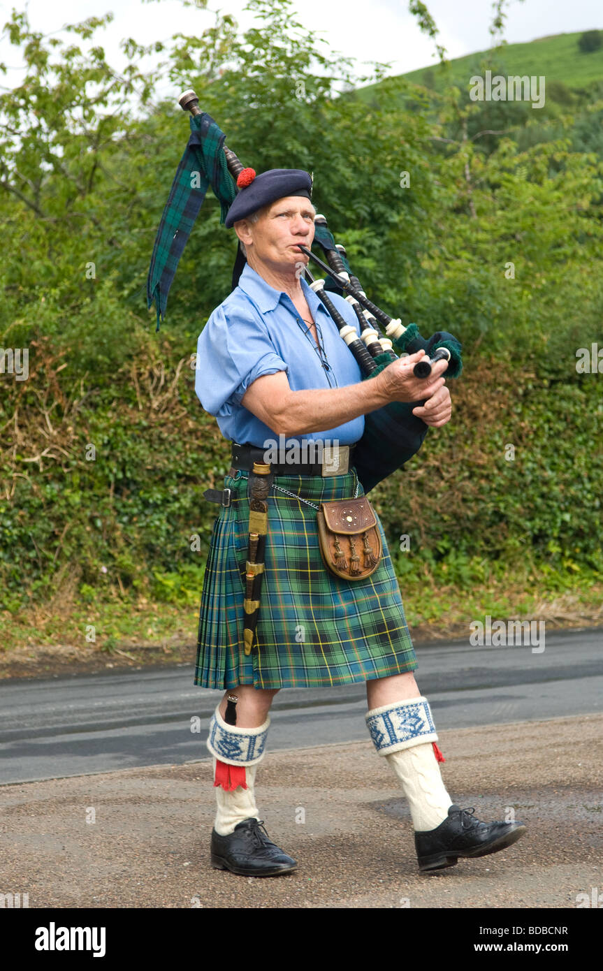A Scotsman playing the bagpipes and wearing traditional Scottish dress Kilt, sporran etc. Stock Photo