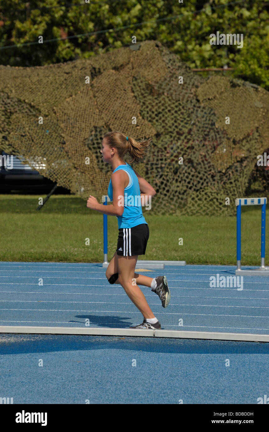 Female teen runner at the Track and Field competition during the