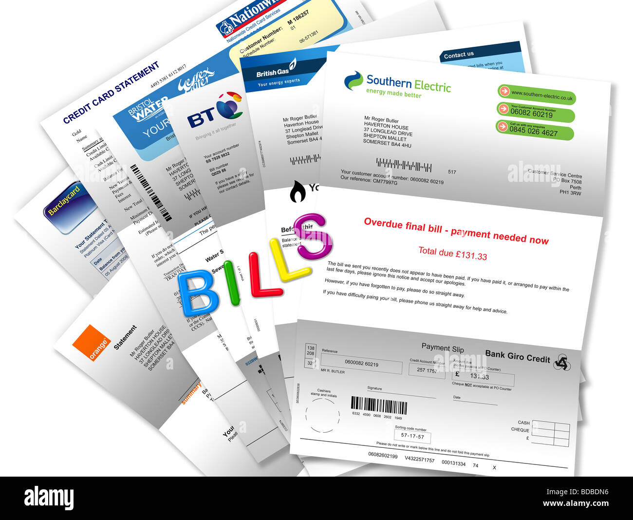 Bills (gas, electricity, telephone, mobile, water and credit cards) attached to fridge door by magnetic letters spelling ‘BILLS' Stock Photo