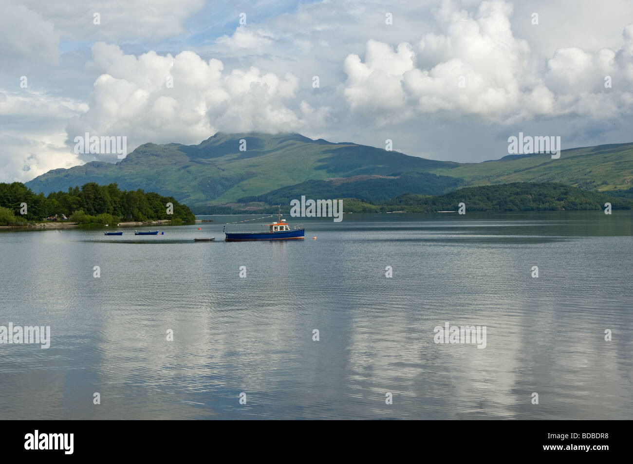 Pleasure or tourist sightseeing boat on Loch Lomond just off a village called Luss, Scotland. Stock Photo