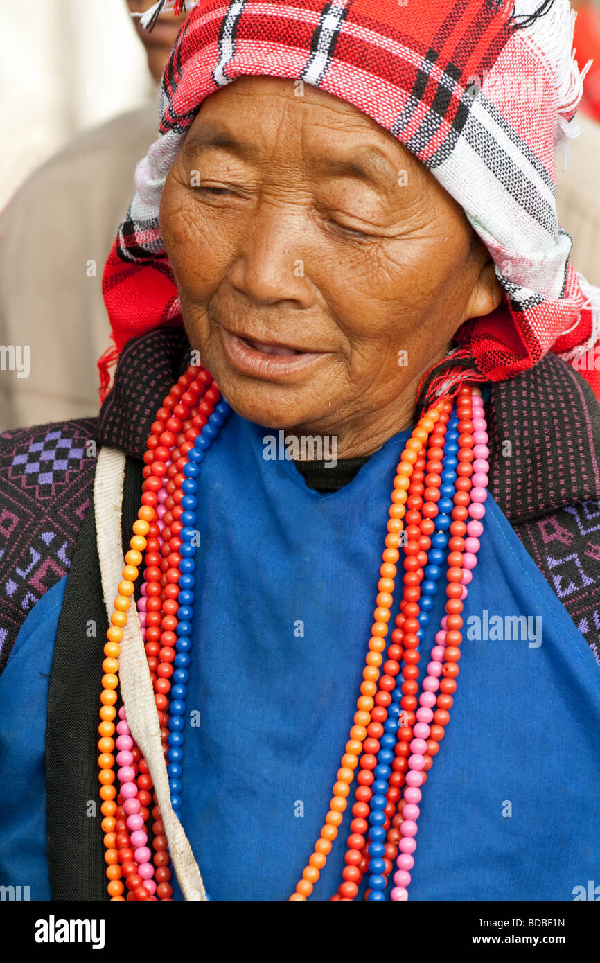 Hani Tribal woman with headdress at Xiding market, Yunnan, China Stock Photo