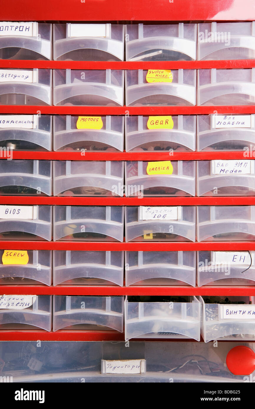 plastic cupboard with spare parts at computer workshop Stock Photo