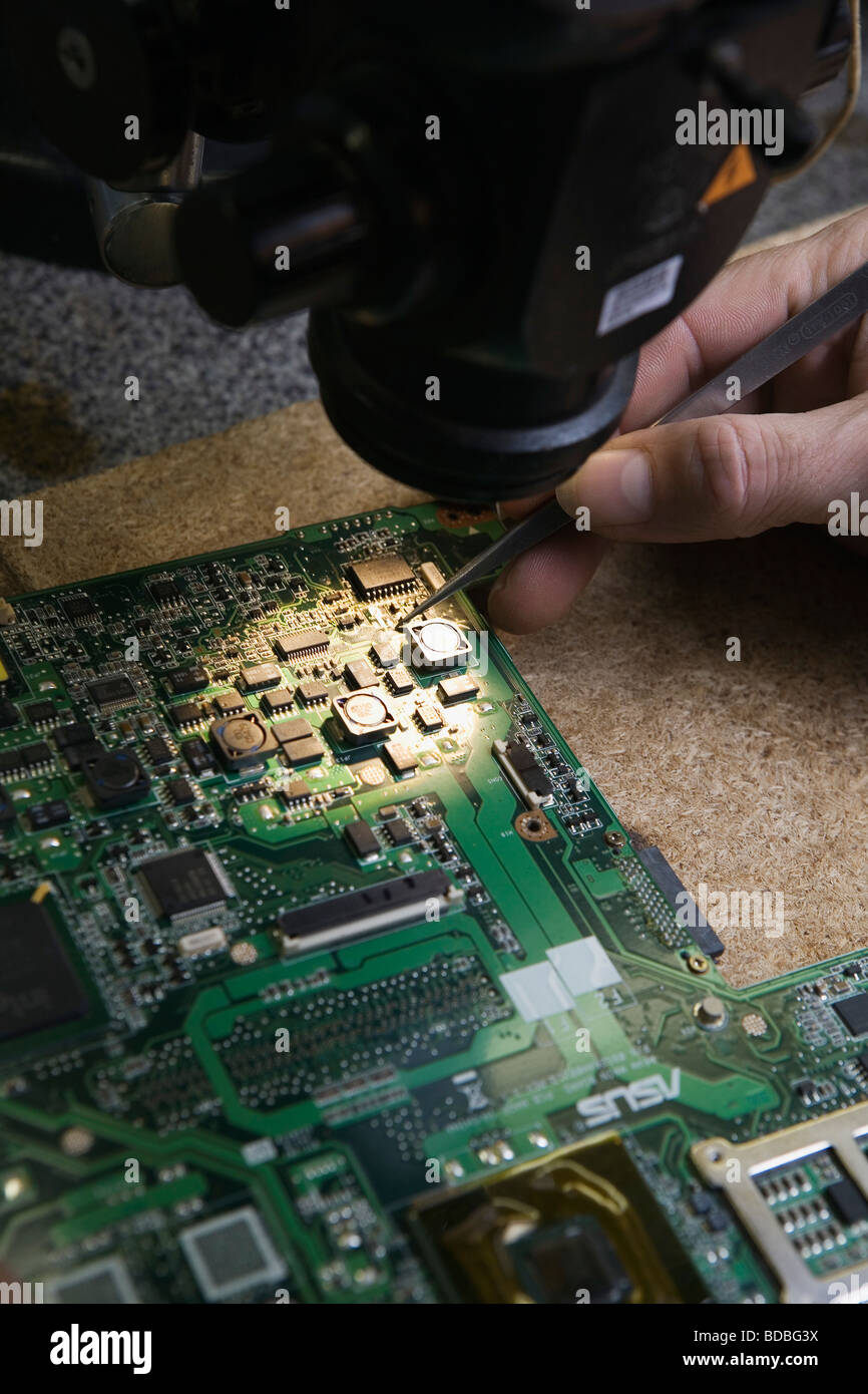 close-up of worker repairing motherboard of computer Stock Photo - Alamy