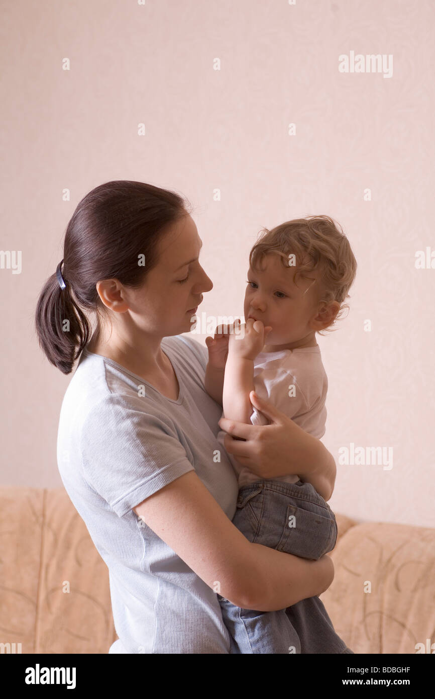mother holding little son in her arms Stock Photo - Alamy