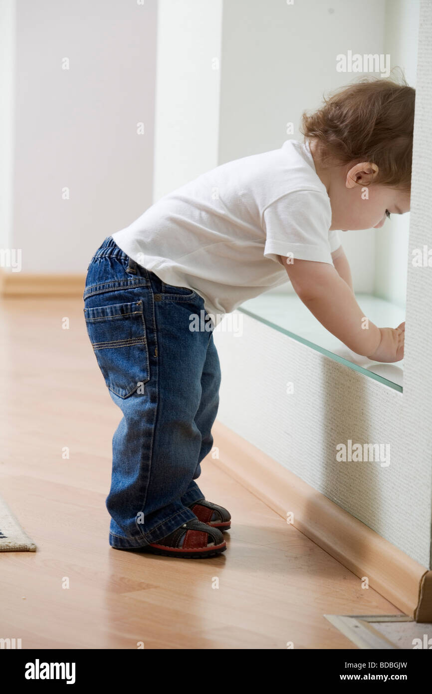 young boy starting to walk at home Stock Photo