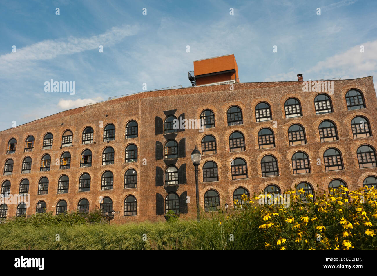 Restored factory building featuring shuttered and arched windows on the ...