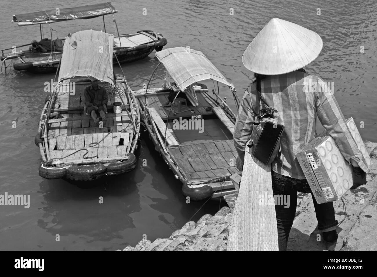 Vietnamse woman heading for the local transport in Cat Ba bay, Cat Ba Island, Vietnam Stock Photo