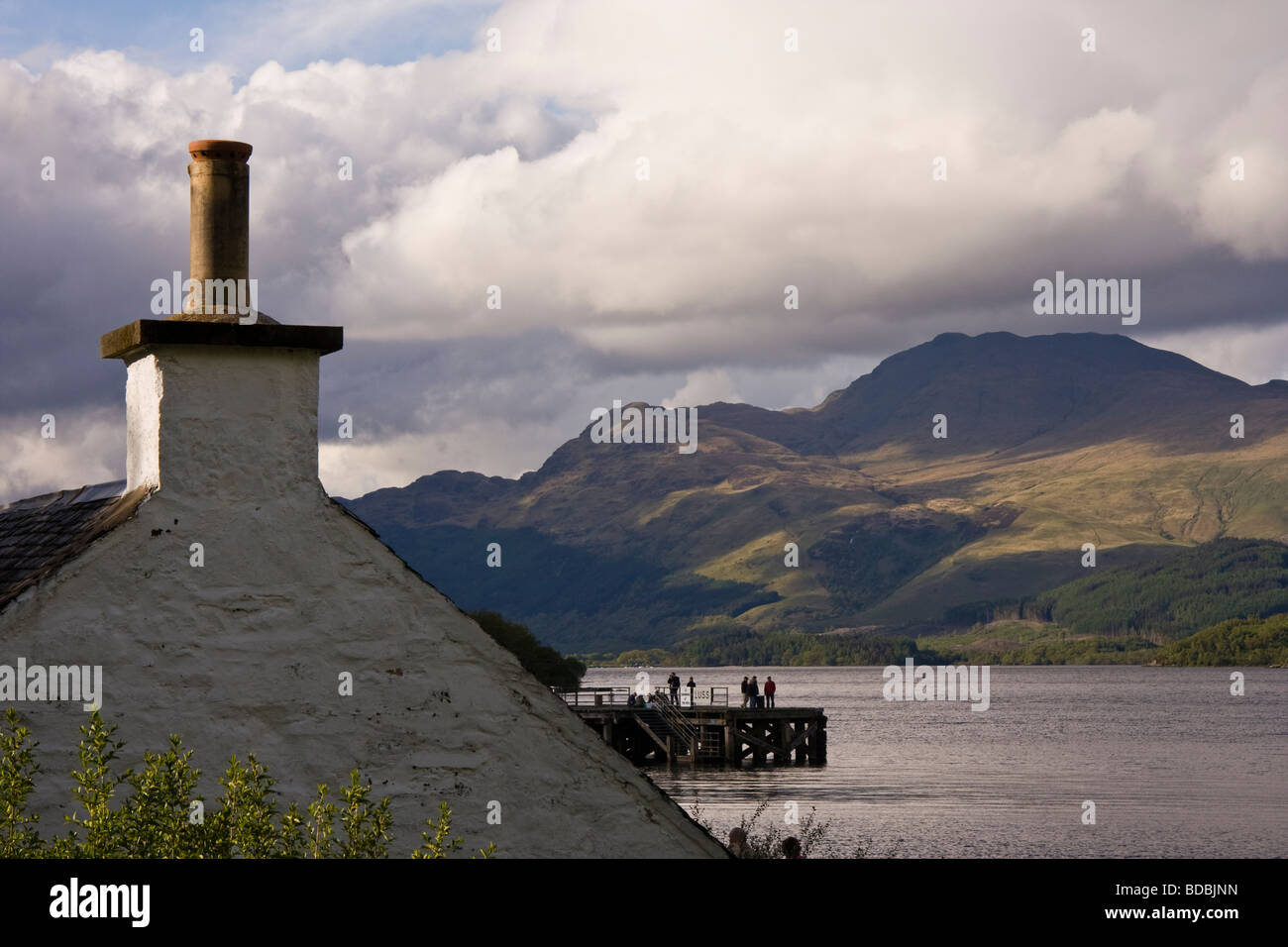 Traditional house and pier in Luss village Loch Lomond Scotland UK