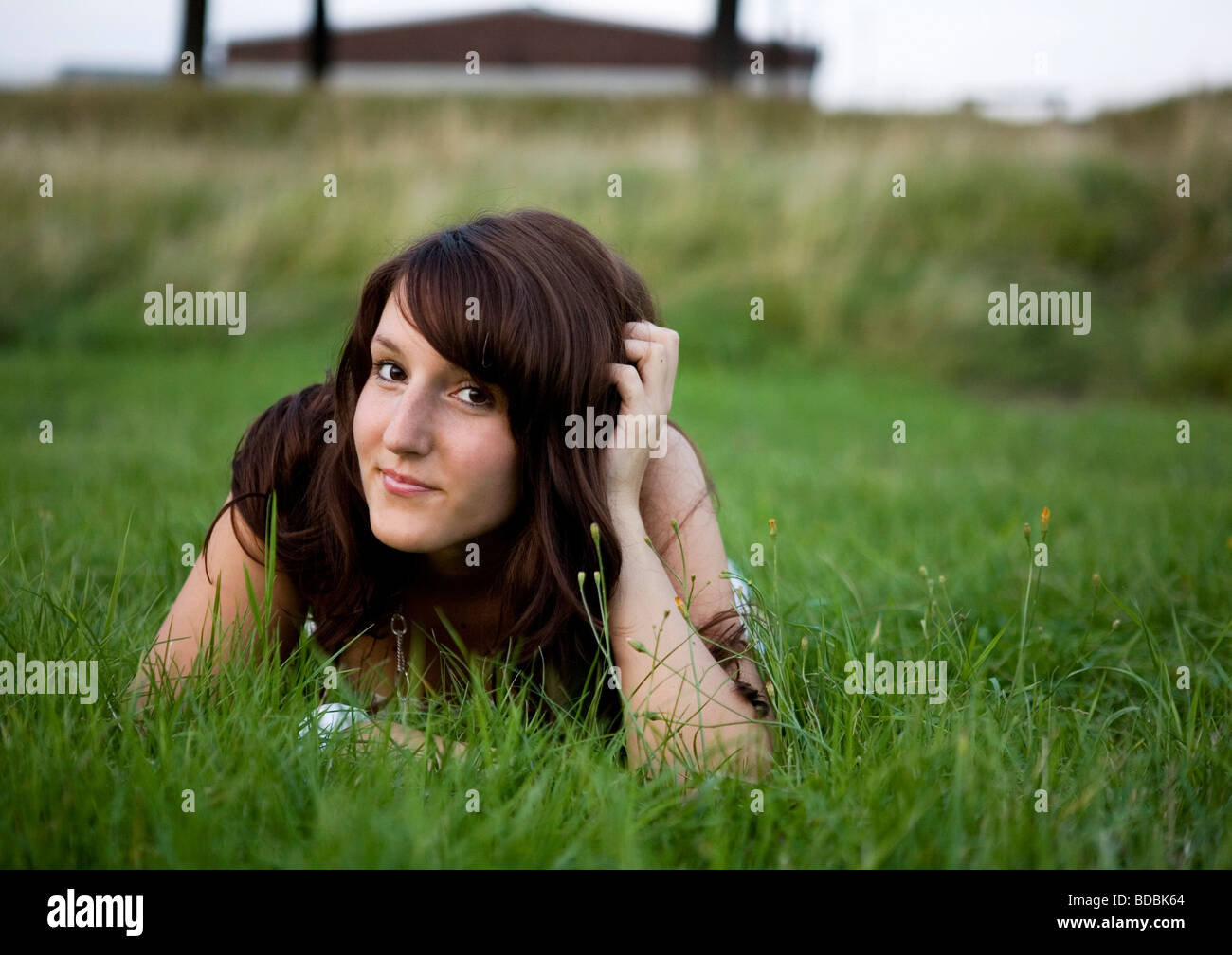 portrait of young woman lying in grass Stock Photo - Alamy