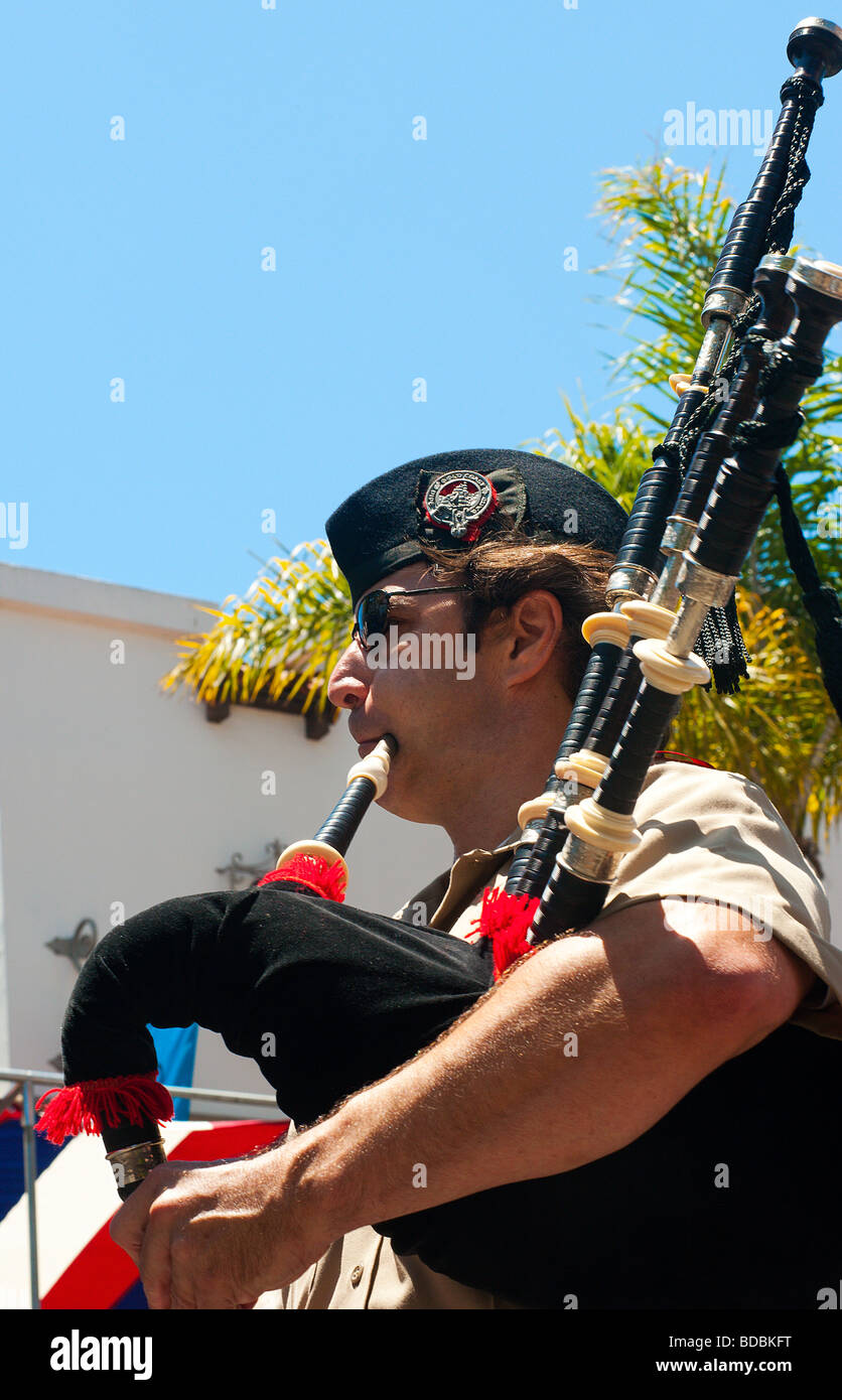 A member of the the Gold Coast Pipe Band is playing his bagpipe during the 4th of July parade in