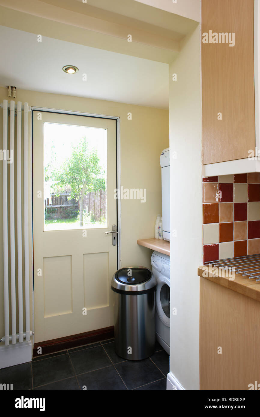 Vertical Radiator Beside Half Glazed Door In Small Utility