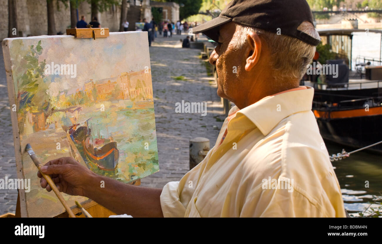 Painter, artist painting onto canvas of a canal boat moored on the River Seine, Paris Stock Photo