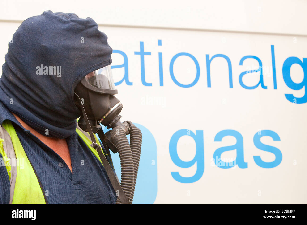 A Britiush Gas worker wears protective gas mask prior to cutting through the gas main as part of an upgrade of piping Stock Photo