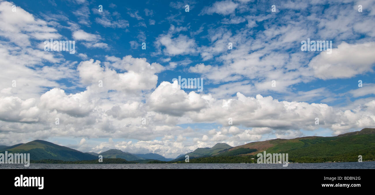 Cloud formation over Loch Lomond with small fishing boat on Loch Lomond. Stock Photo