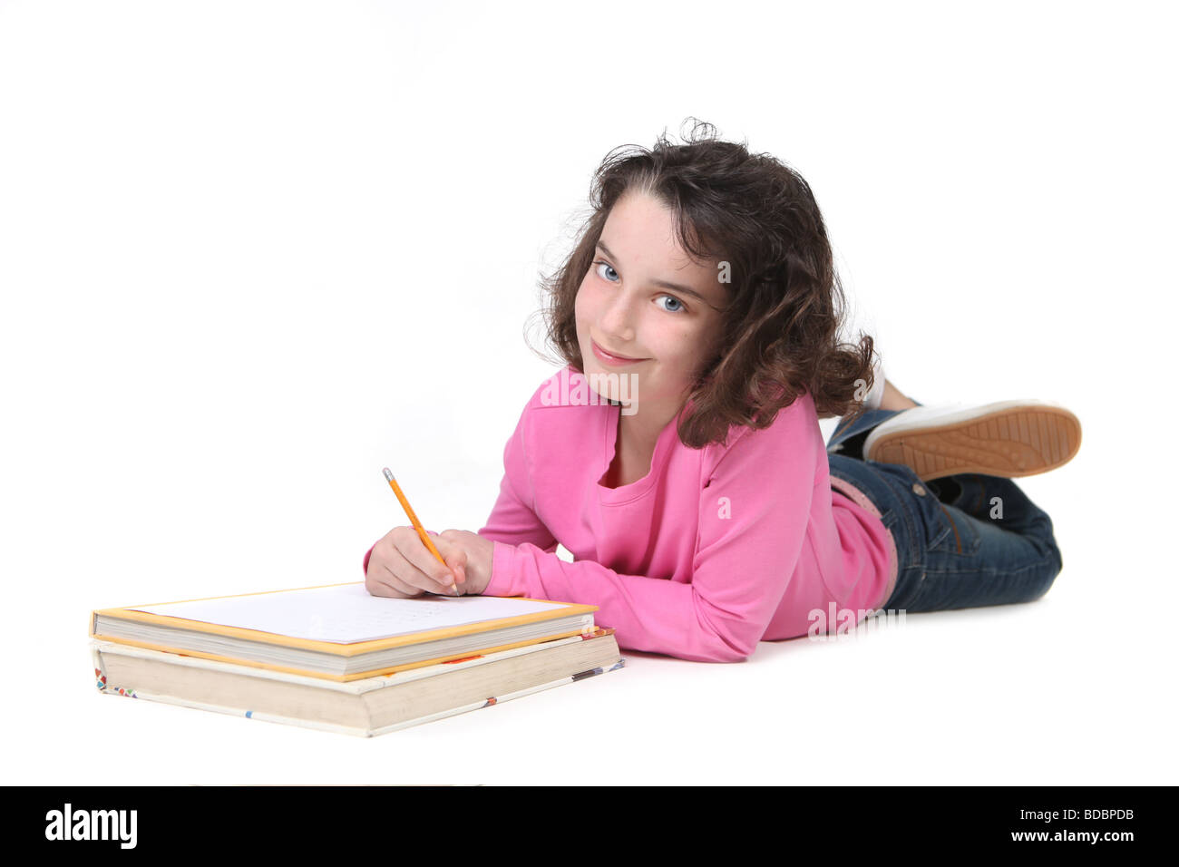 Pretty Young Girl Doing Her Homework In White Background Stock Photo
