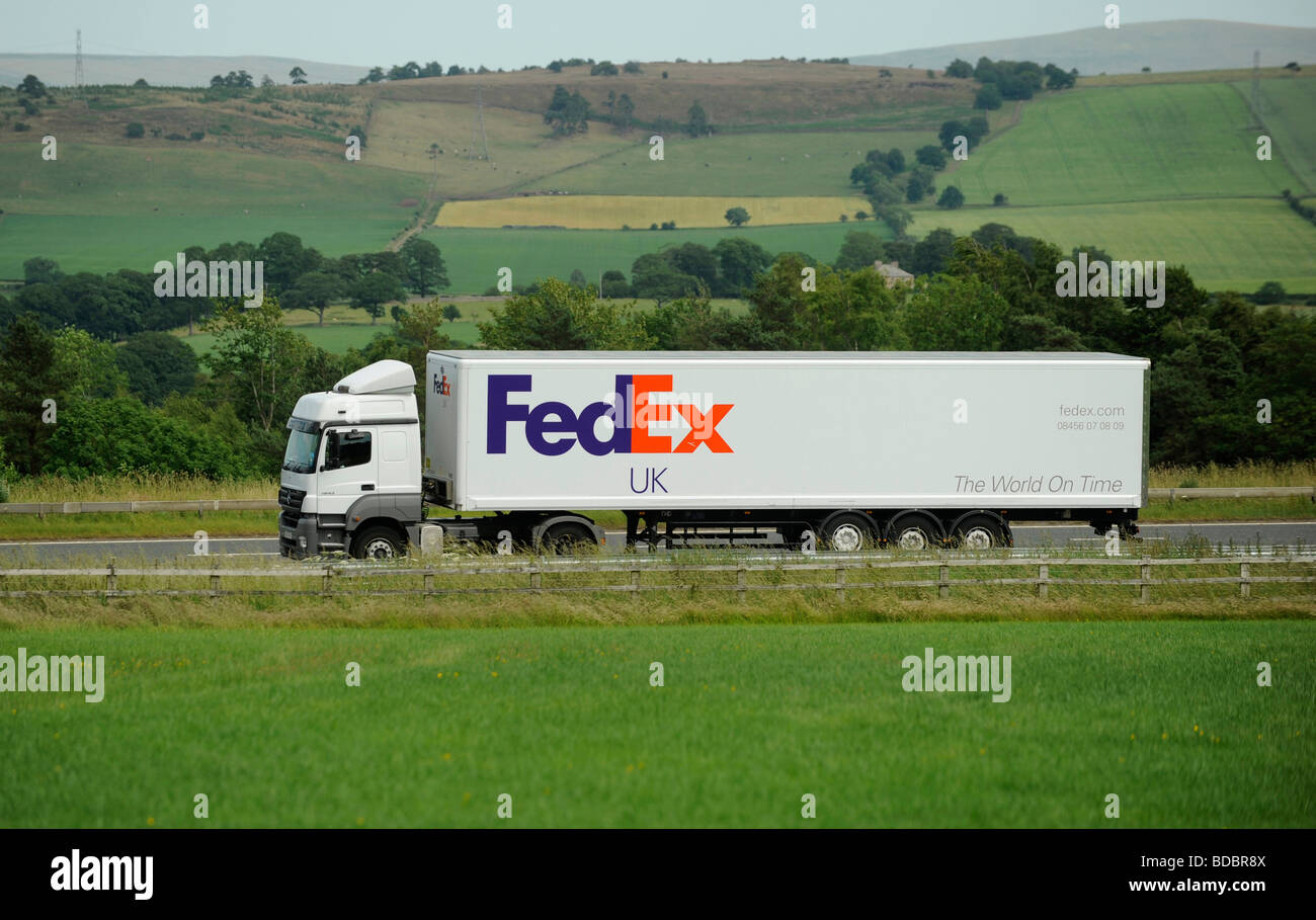 Mercedes truck and box van trailer FedEx Fed Ex Federal Express parcels carrier Stock Photo