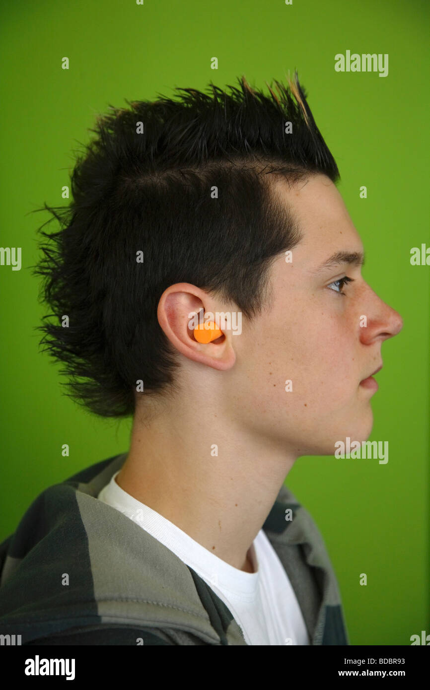 Teenager with earplug Stock Photo