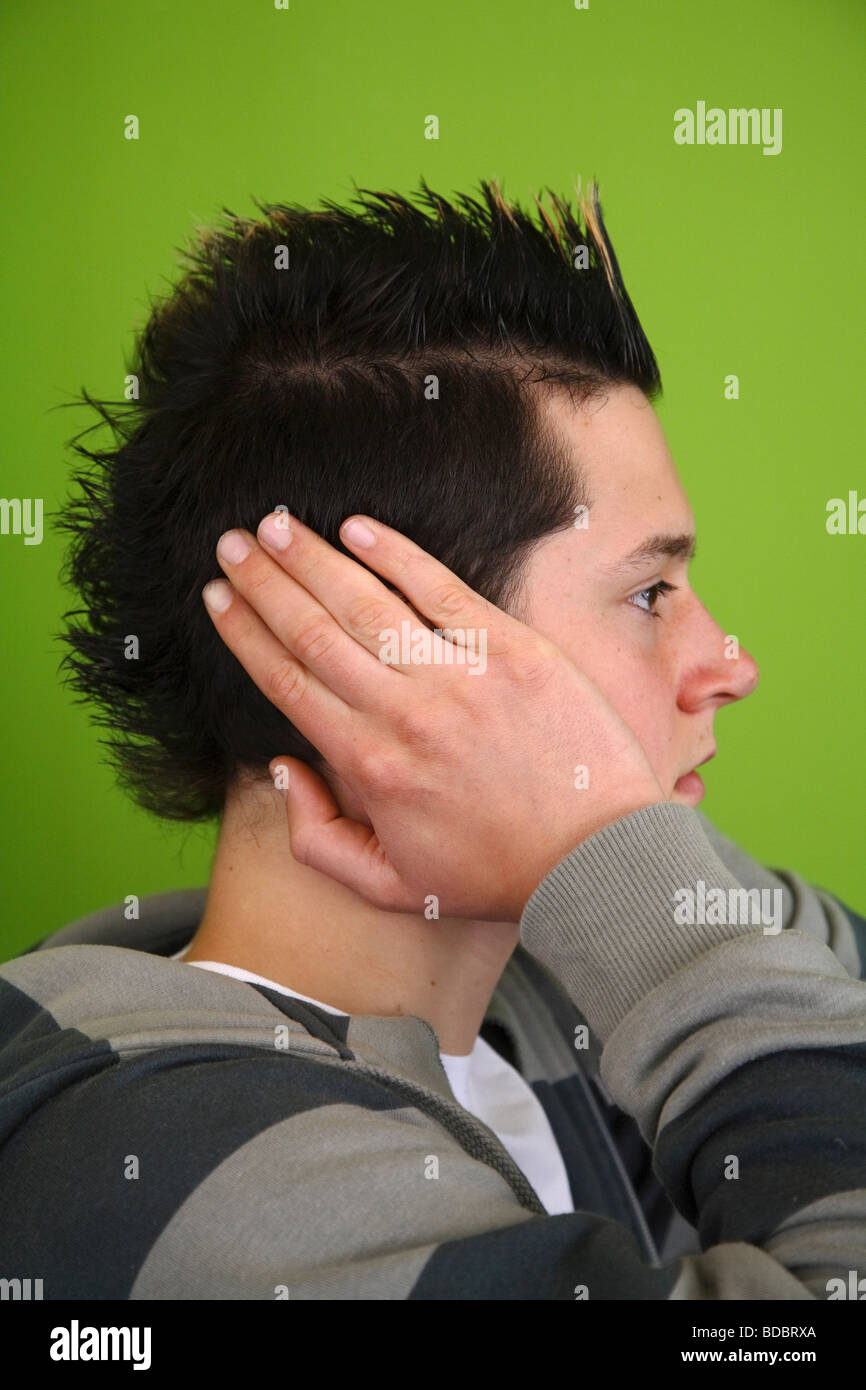 Teenager covering his ears Stock Photo