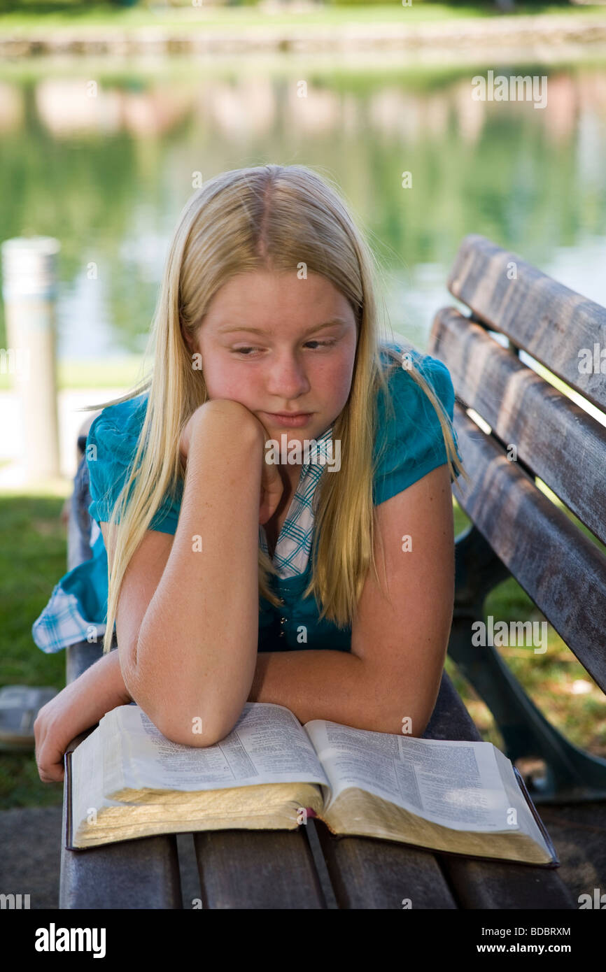young person people 11-13 year old years olds Caucasian Tween tweens  Junior high girl reading Bible meditating reflecting  MR Myrleen Pearson Stock Photo