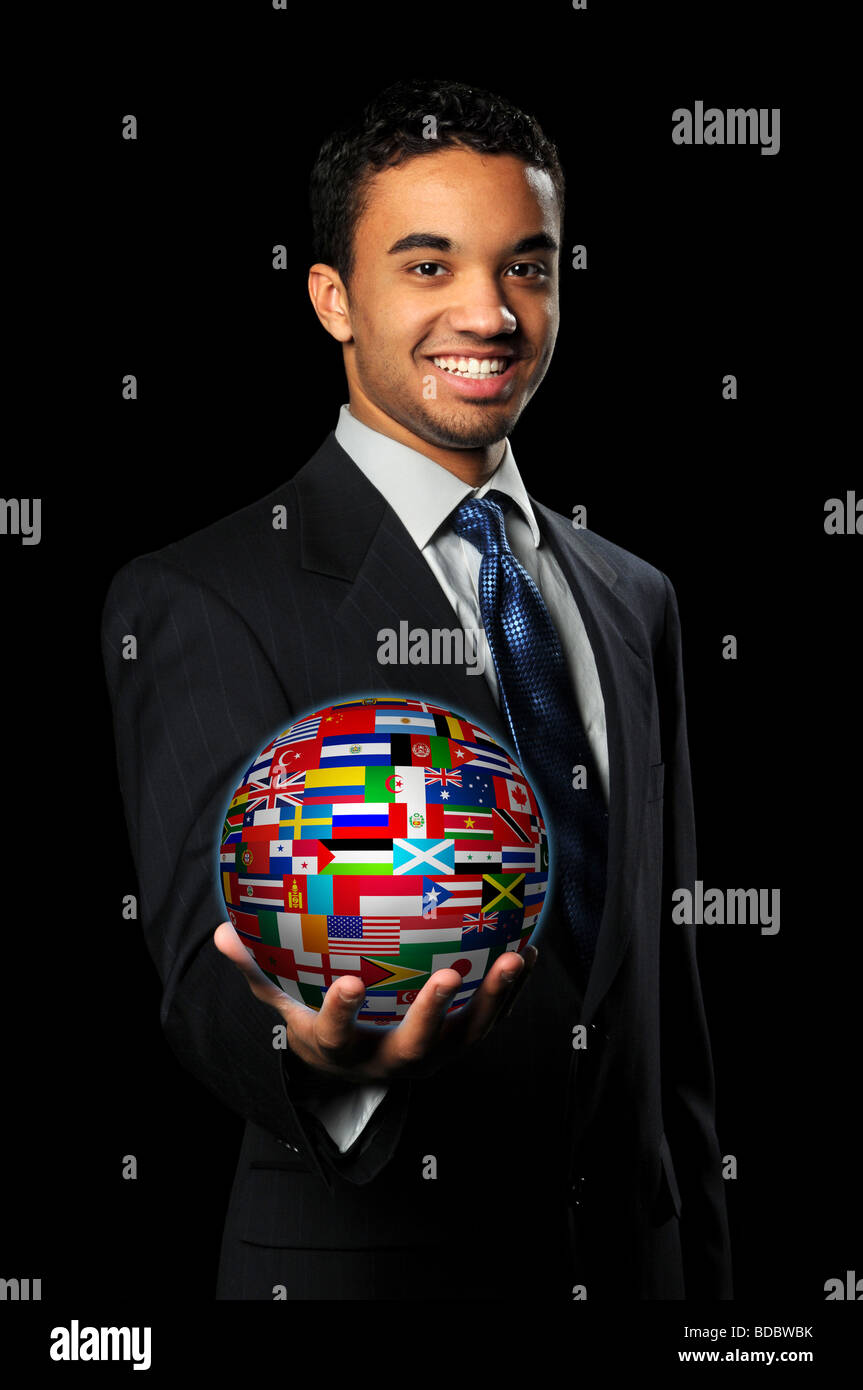 Young multiracial businessman holding sphere with world flags Stock Photo